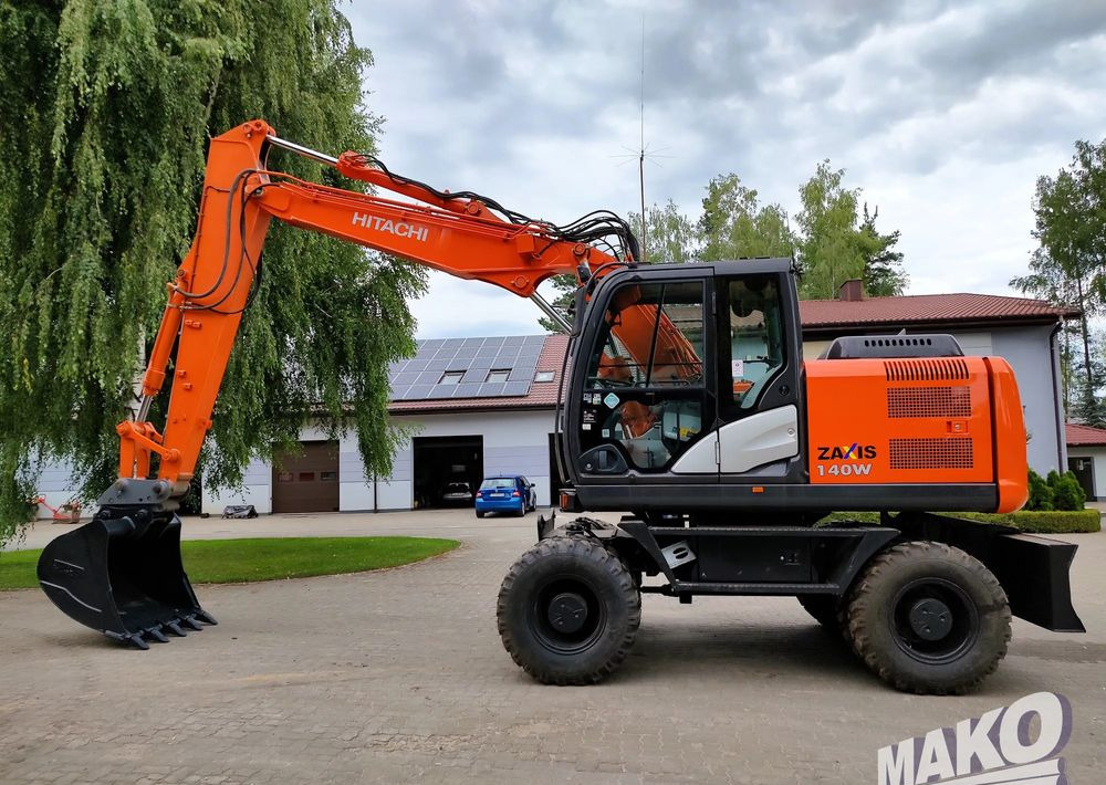 Hitachi ZX 140 - Tekerlekli ekskavatör: fotoğraf 1 Hitachi ZX 140 - Tekerlekli ekskavatör: fotoğraf 1