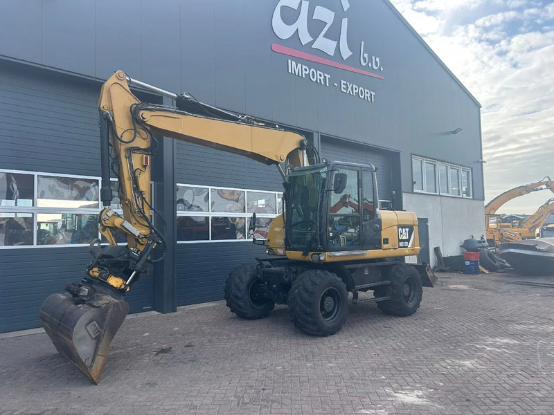 Caterpillar M313D - Tekerlekli ekskavatör: fotoğraf 1 Caterpillar M313D - Tekerlekli ekskavatör: fotoğraf 1