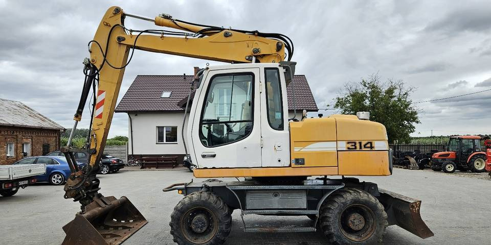 Koparka kołowa Liebherr A314 Litronic 9350 h 4 łyżki kołówka - Tekerlekli ekskavatör: fotoğraf 1 Koparka kołowa Liebherr A314 Litronic 9350 h 4 łyżki kołówka - Tekerlekli ekskavatör: fotoğraf 1