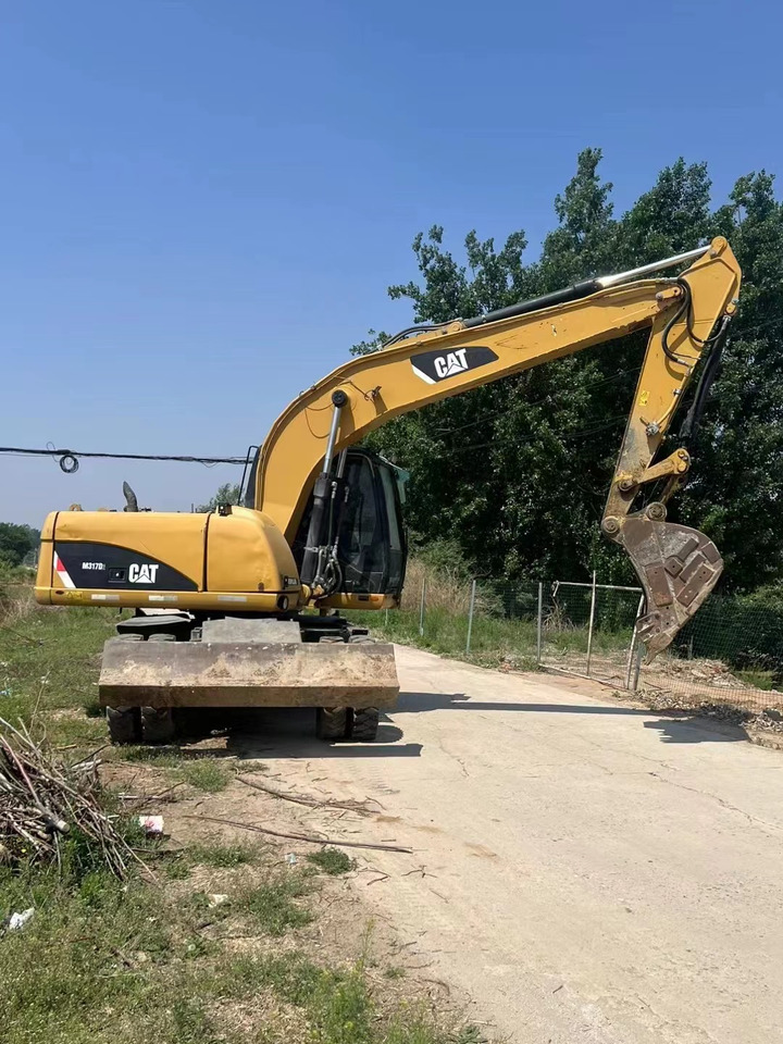 CATERPILLAR M317 - Tekerlekli ekskavatör: fotoğraf 1 CATERPILLAR M317 - Tekerlekli ekskavatör: fotoğraf 1