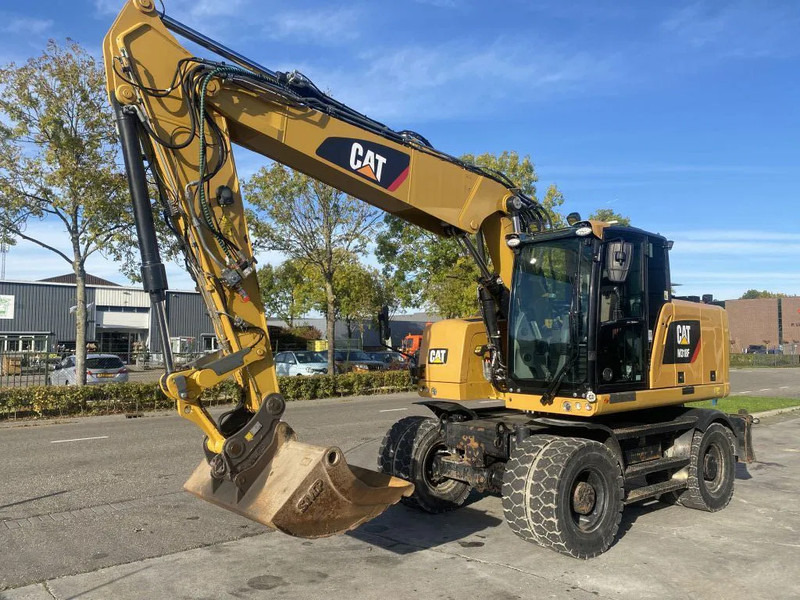 Caterpillar M318F - Tekerlekli ekskavatör: fotoğraf 1 Caterpillar M318F - Tekerlekli ekskavatör: fotoğraf 1