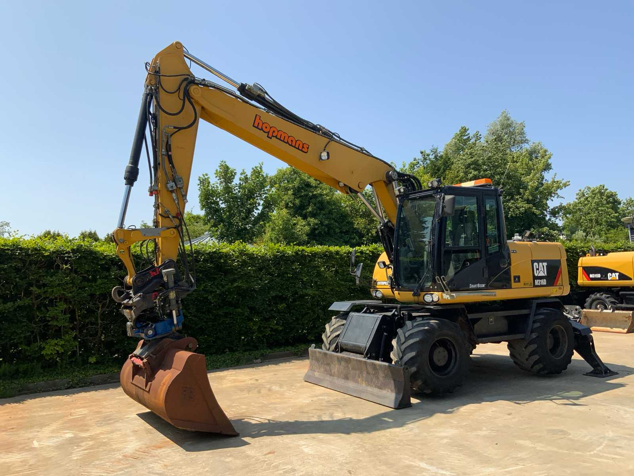 Caterpillar M316D - Tekerlekli ekskavatör: fotoğraf 1 Caterpillar M316D - Tekerlekli ekskavatör: fotoğraf 1