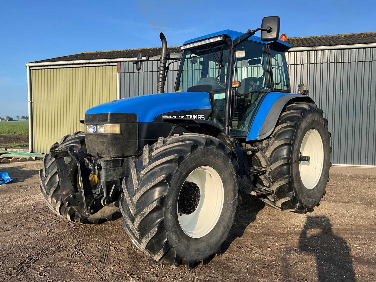 New Holland TM165 - Traktör: fotoğraf 1 New Holland TM165 - Traktör: fotoğraf 1